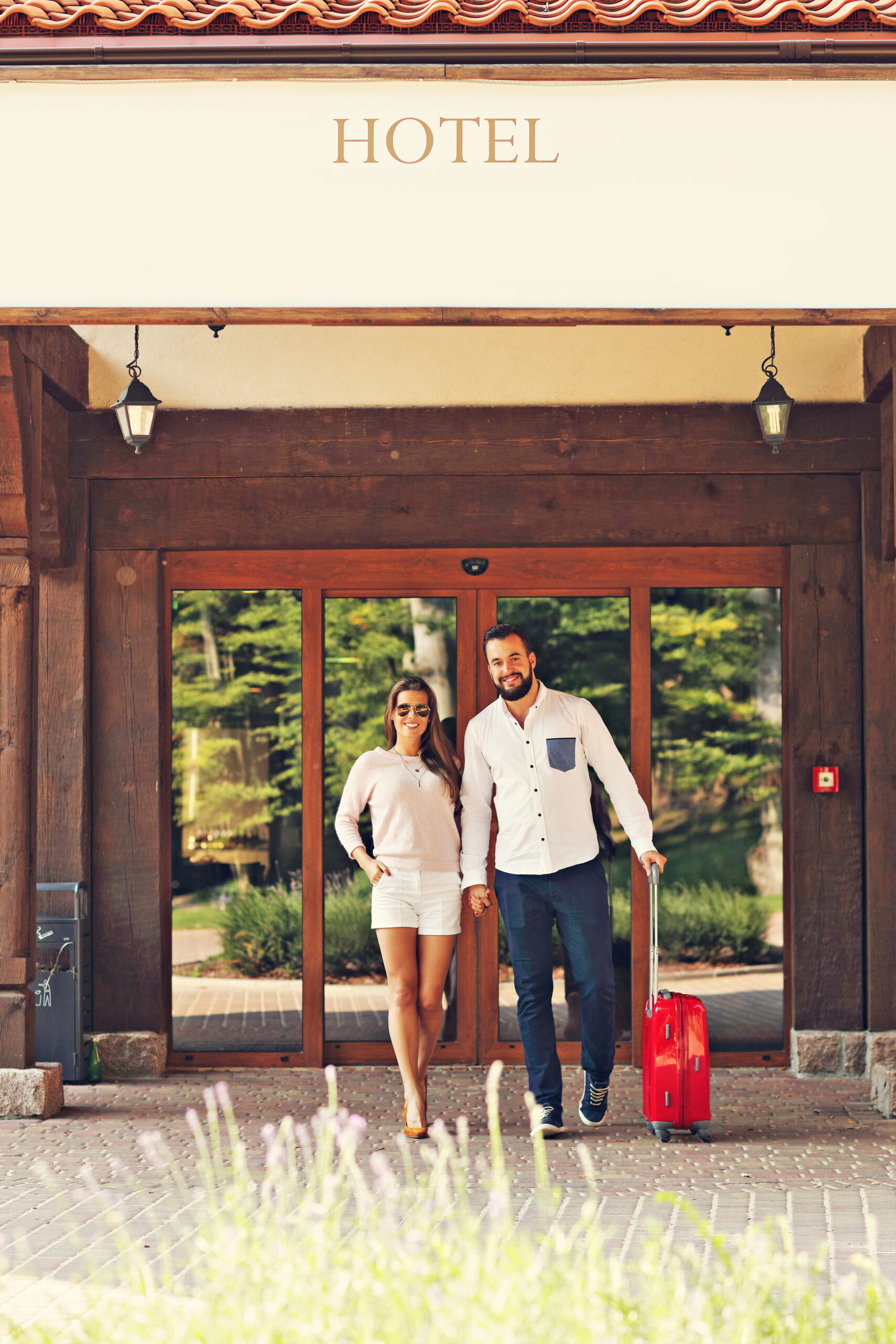 Picture of young couple walking out of hotel